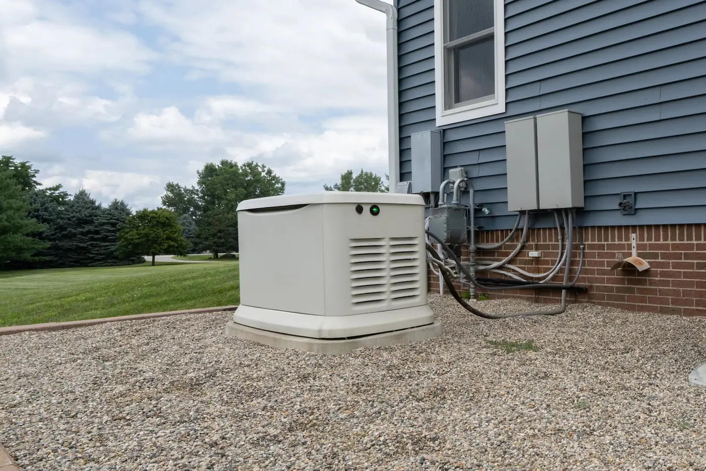 A residential Generac standby generator showing a green status light after service.